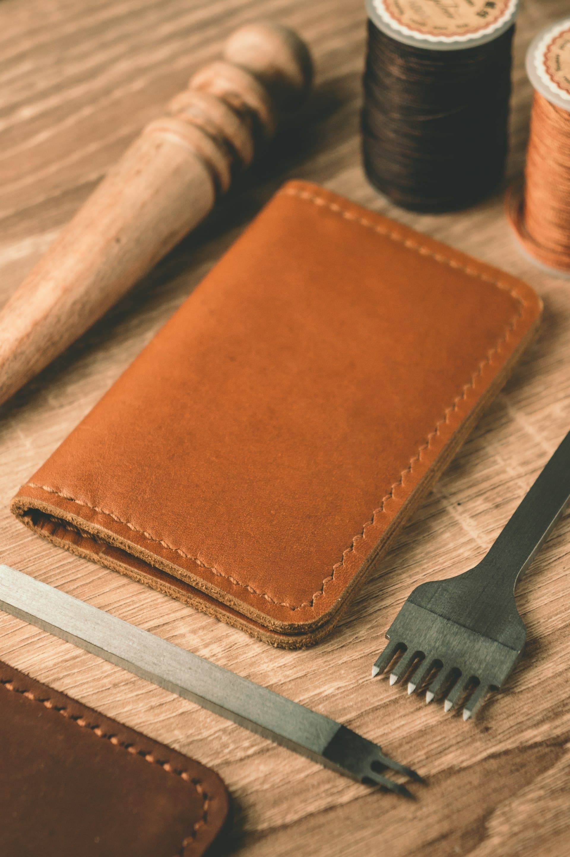 Leather working tools and a hand-stitched card holder